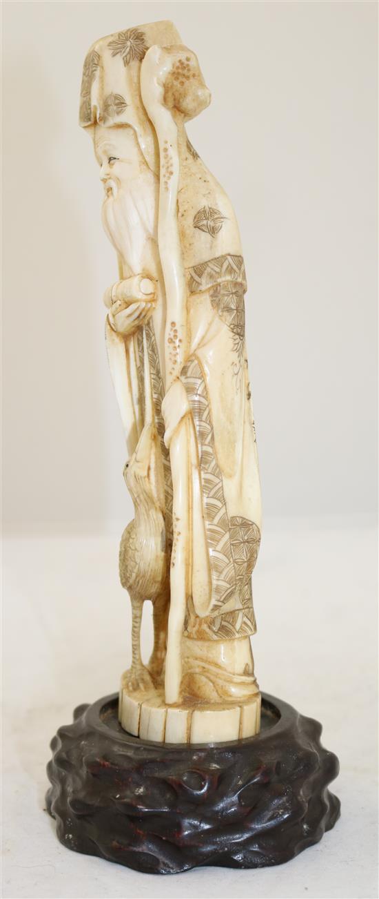 A Japanese walrus ivory figure of Fukurokuju, early 20th century, height 24.5cm incl. wood stand